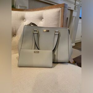 Light grey Kate Spade crossbody purse with wallet.